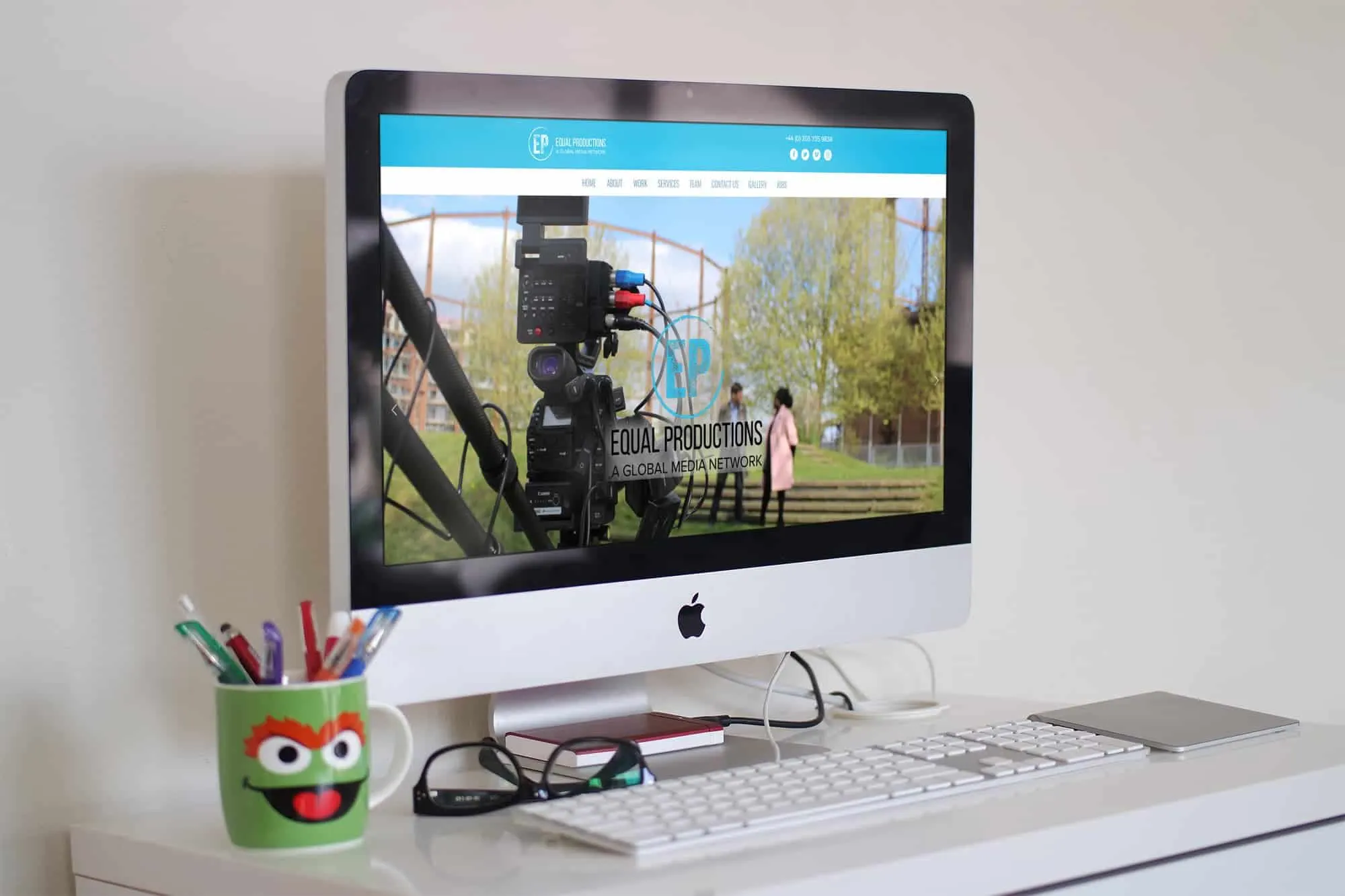 The Equal Productions site on a desktop screen, showing a film crew on location