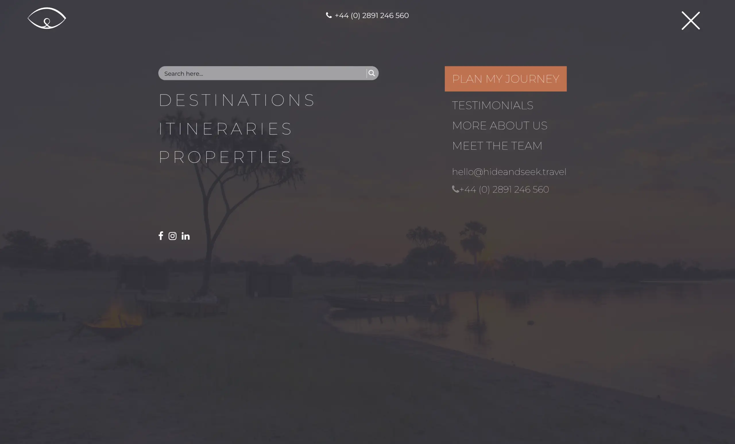 The Hide & Seek Travel menu open full screen: a search box above Destinations, Itineraries and Properties, over a darkened photograph of a river at dusk